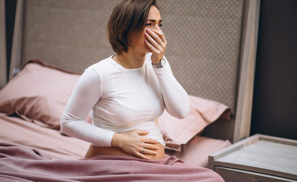 Young pregnant woman having toxicosis in first trimester
